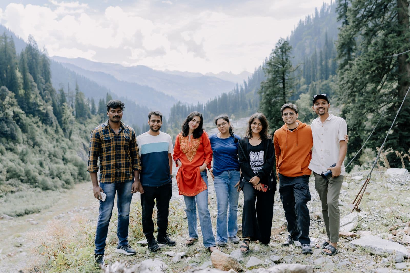 Friends standing together in a mountain valley after a hike