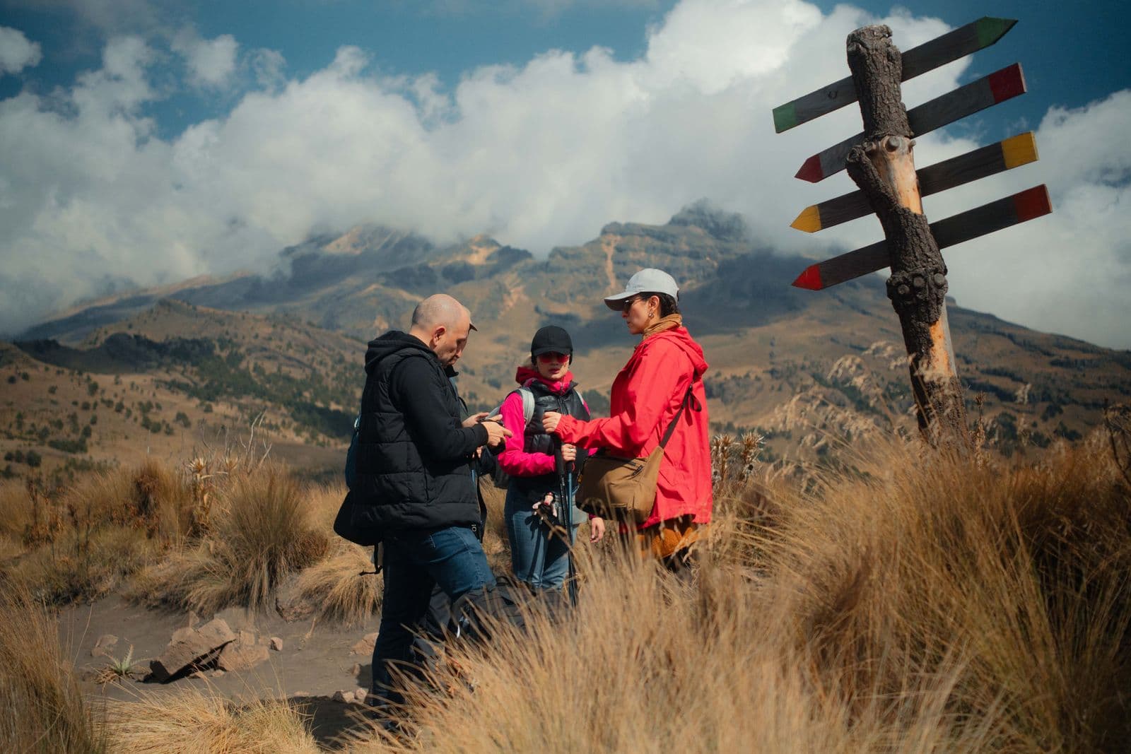 Friends pausing together on a mountain trail