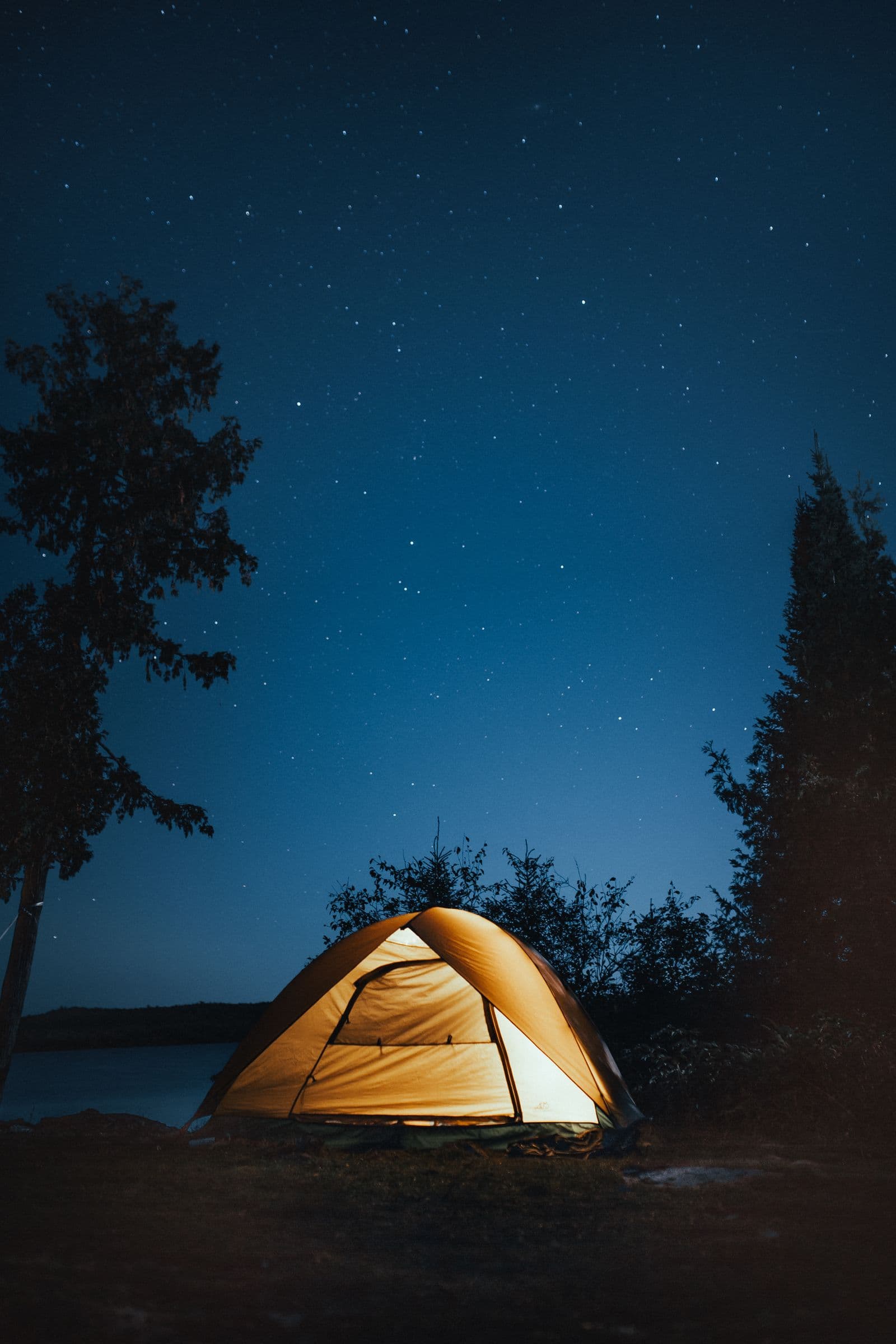 Friends camping by a lake where the group can stay put and talk